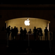 Silhouettes of people browsing in the Grand Central Apple store.